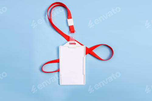 Preview: Blank White ID Card Holder With A Red Lanyard Isolated On Blue Background