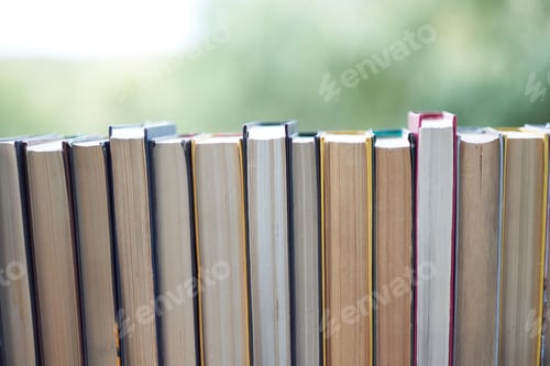 Preview: row of vintage books stand on a table.
