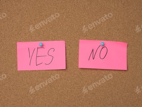 Preview: Two pink sheets are hanging on a brown cork board, the inscription is yes no