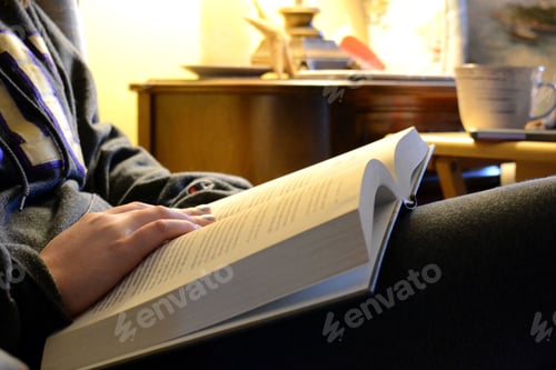 Preview: Female teenager reading a textbook book studying for class test. High school, college, University.