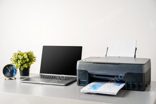 Preview: Printer and laptop on grey table in office