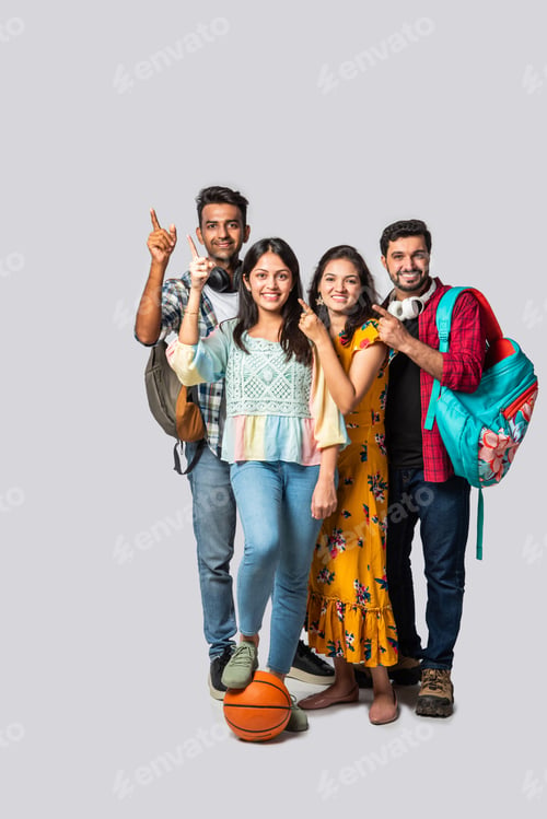 Preview: Indian asian college student against white pointing or advertising at blank copy space