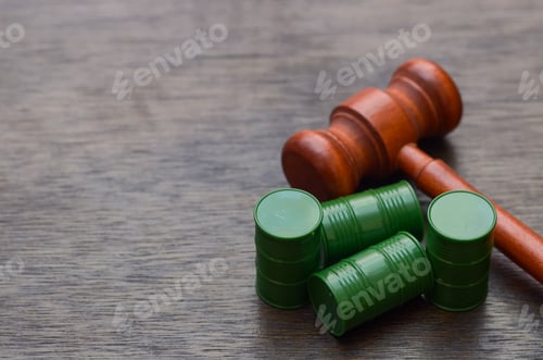 Preview: Wooden Gavel and Toxic Waste Barrels Symbolizing Legal Action on Pollution