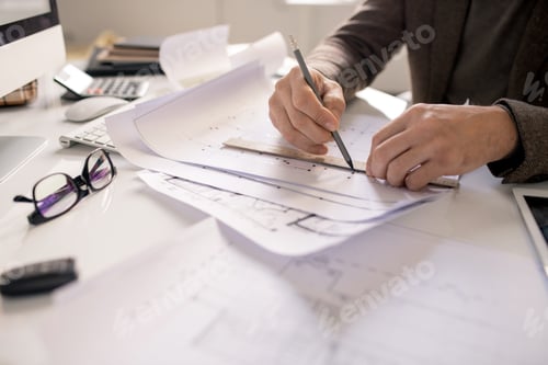 Preview: Hands of architect with pencil and ruler drawing line while working over sketch