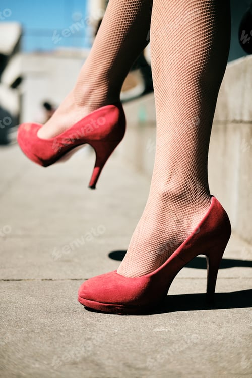 Preview: Woman's Legs Wearing Red Heels in Urban Setting