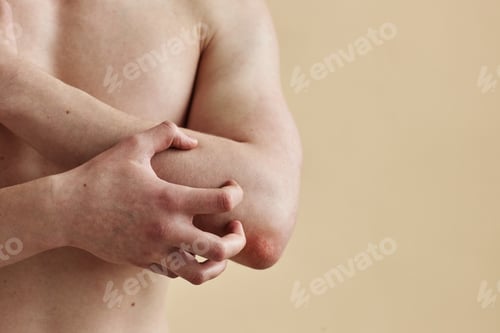 Preview: Detail shot of unrecognizable man scratching