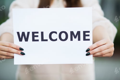 Preview: Women business with the poster with welcome message