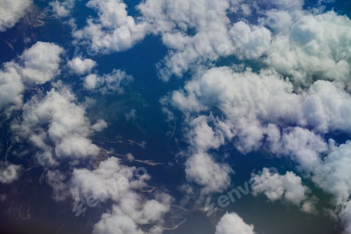 Preview: Aerial view of white fluffy clouds over landscape