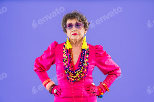 Preview: Happy and funny senior old woman on colorful background
