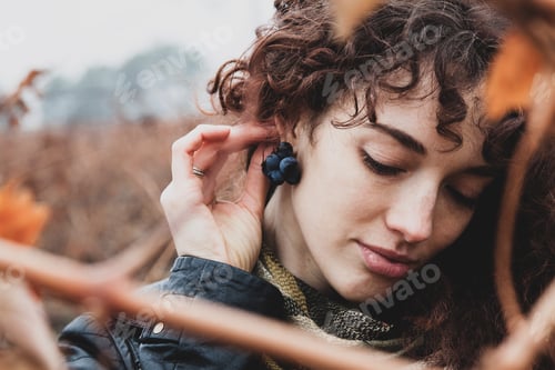 Preview: beautiful girl with curly hair. in the vineyard, grape earrings