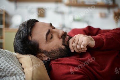 Preview: Handsome elderly man relaxing indoors on a cozy afternoon with a calm expression