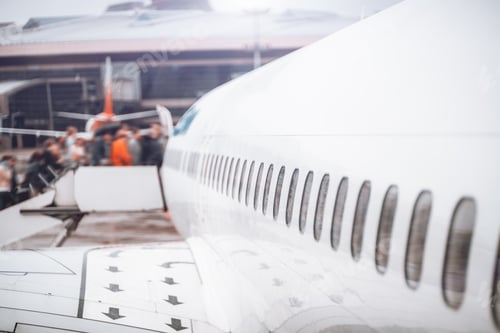 Preview: People entering white airplane