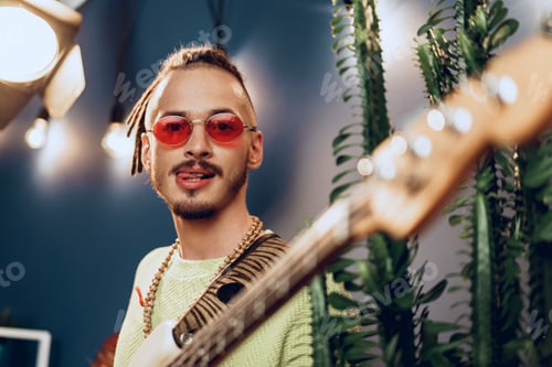 Preview: Man with Guitar Poses in Red Sunglasses