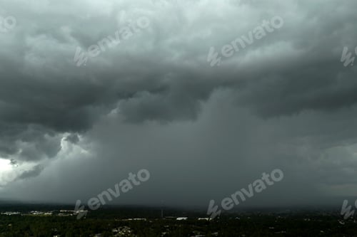 Preview: Stormy cumulonimbus clouds forming before thunderstorm on dark sky.