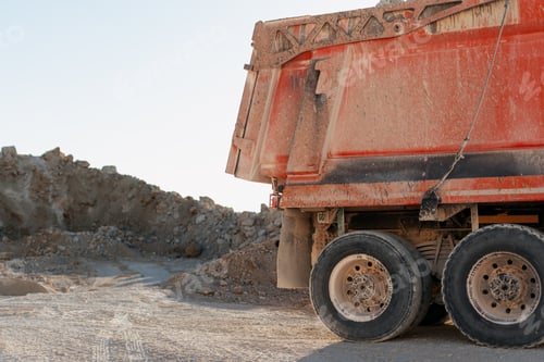 Preview: Dusty dump truck parked in a quarry during daytime