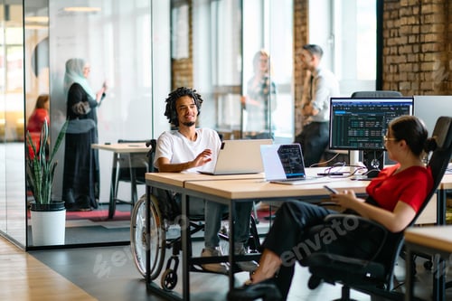 Preview: A young business group, including an African American businessman in a wheelchair, collaborates