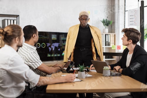 Preview: Male company workers in formal wear sitting at office desk and listening to team leader