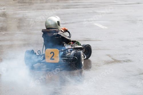 Preview: Karting - driver in helmet on kart circuit