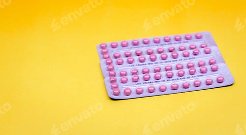 Preview: Pink pills in blister pack on yellow background