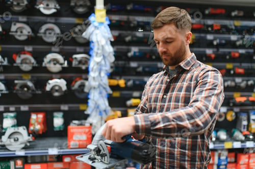 Preview: A man in a hardware store chooses a new orbital sander