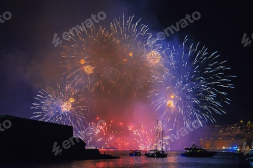 Preview: View from water on show of fireworks against background of historical bastions of Valletta
