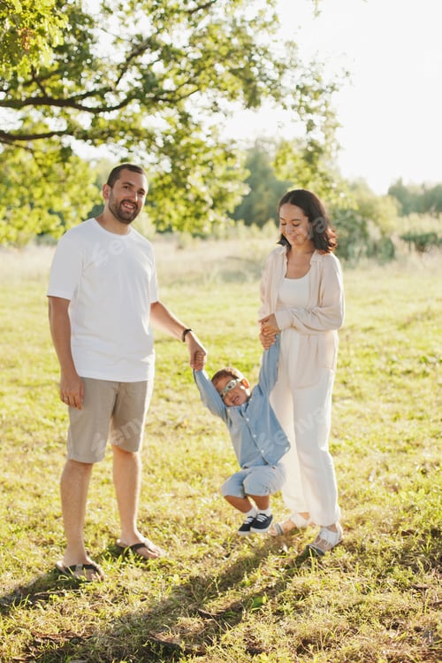 Preview: Happy family mom, dad and son playing outdoors on a walk in the park in summer, family fun outside