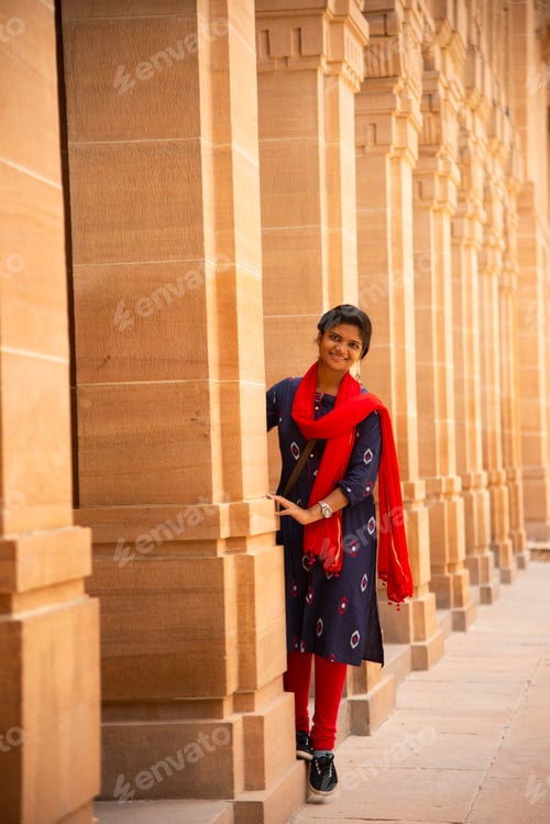 Preview: Indian woman standing between arches and Pillars.