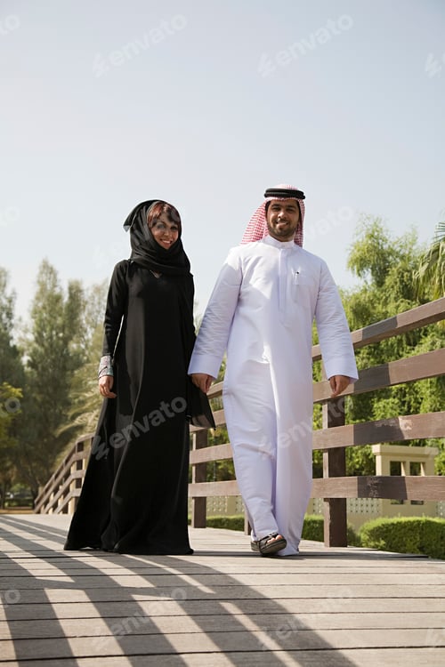 Preview: Couple taking a leisurely walk on a sunny bridge