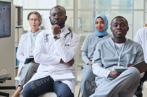 Preview: Group of medical specialists sitting at seminar