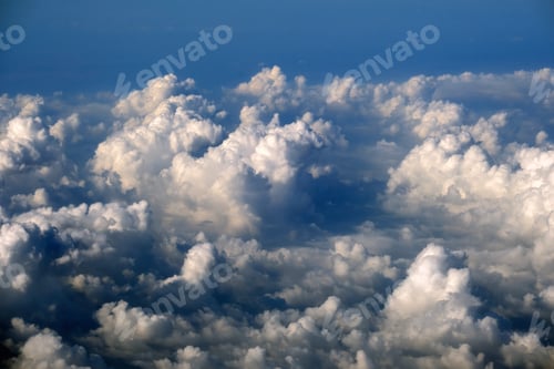 Preview: Aerial view from above at high altitude of dense puffy cumulus clouds flying.