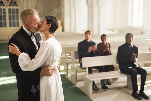 Preview: Loving Senior Couple in First Kiss in Church on Wedding Day