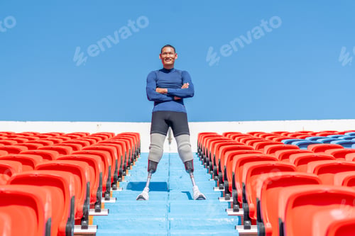 Preview: Sport man athlete prosthesis legs stand with arm crossed on stairs with happiness look at camera