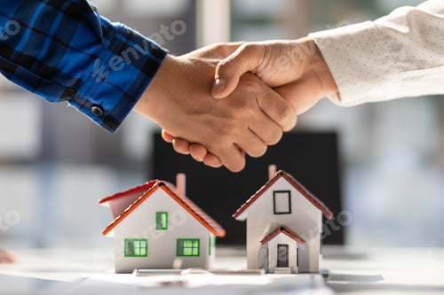 Preview: Real estate agents shake hands after the signing of the contract agreement is complete.