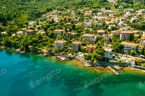 Preview: Beautiful villas near the coast of rocky beach in a small town Lovran, Croatia. Arial view of
