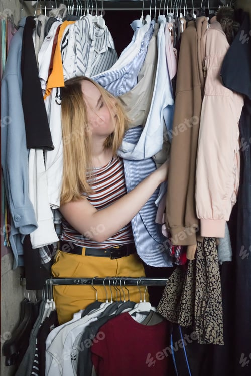 Preview: Spring cleaning,Fast fashion, the girl puts things in order in the closet. A bunch of colorful