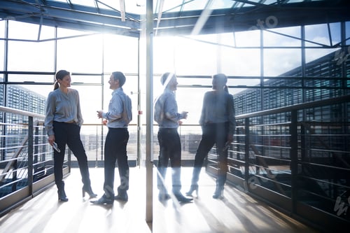 Preview: Businessman and woman talking on office balcony