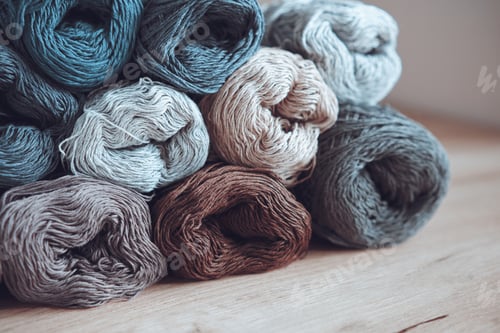 Preview: Stacked skeins of cotton yarn in different colors. Yarn for knitting with needles and crochet.