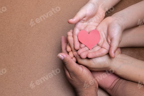 Preview: hands holding red heart image, chocolate background