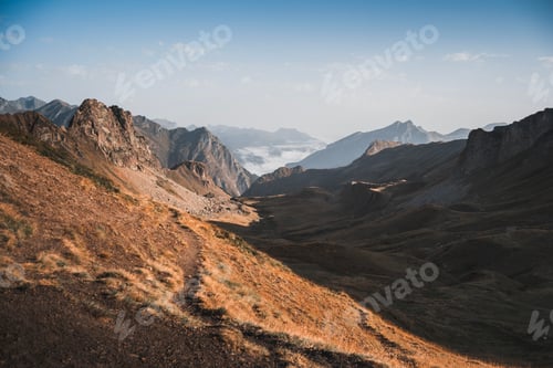 Preview: A golden summer trail winding through the picturesque French Pyrenees at dawn.