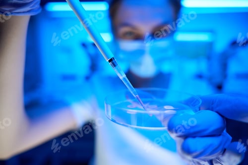 Preview: Woman manipulates biomaterial in a modern scientific laboratory
