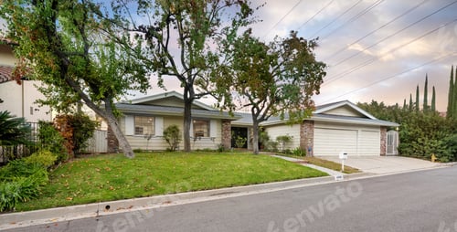 Preview: Two-story white house with trees at corner and driveway in Encino, California