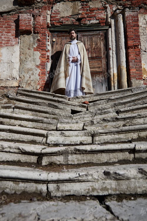 Preview: Middle Aged Caucasian Man Dressed as Priest Standing Outside Historic Church