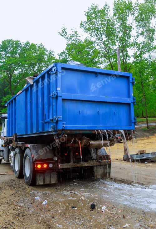 Preview: Loaded dumpster near a litterless metal container without a cover is full of construction debris