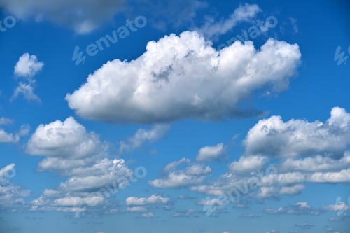 Preview: Bright landscape of white puffy cumulus clouds on blue clear sky.