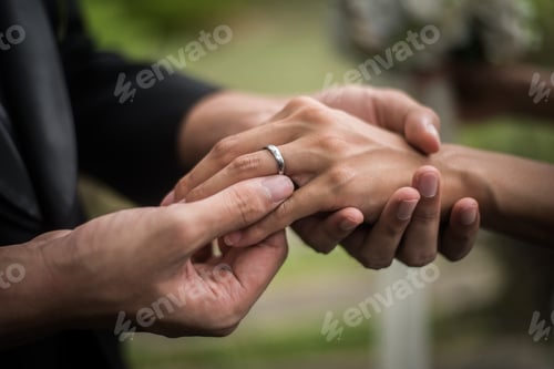 Preview: Close up of groom wears the ring bride in wedding day. Love, happy marry concept.