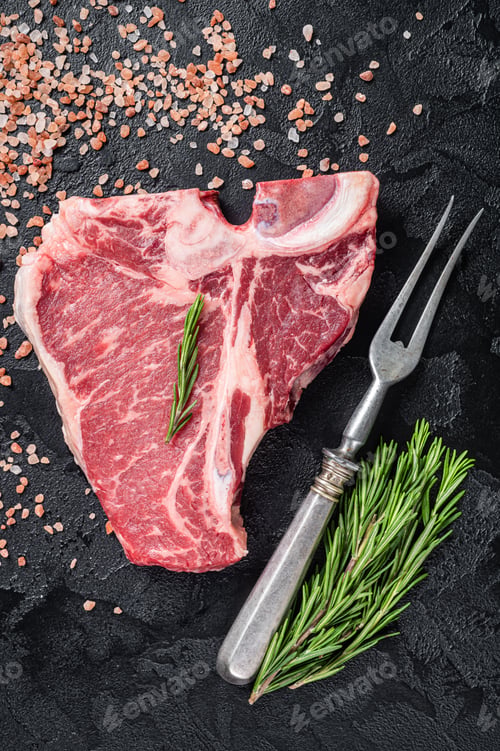 Preview: Raw T bone beef meat steak, porterhouse steak on butcher table with rosemary.