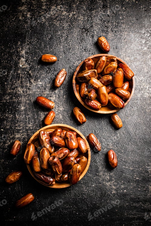 Preview: Two plates of dates on the table.