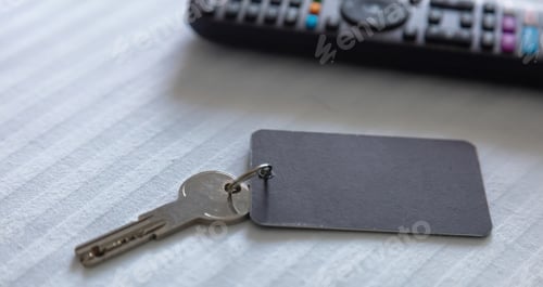 Preview: Steel key ring with blank label for text or number and hotel room door key, closeup