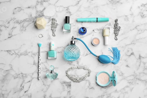 Preview: Flat lay composition with perfume bottles, jewelry and decorative cosmetics on white marble table