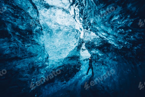 Preview: Traveler walking in blue ice cave
